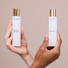 Load image into Gallery viewer, Two alcohol-free perfumes : Bossa Wood and Tropica are being hold by two hands.